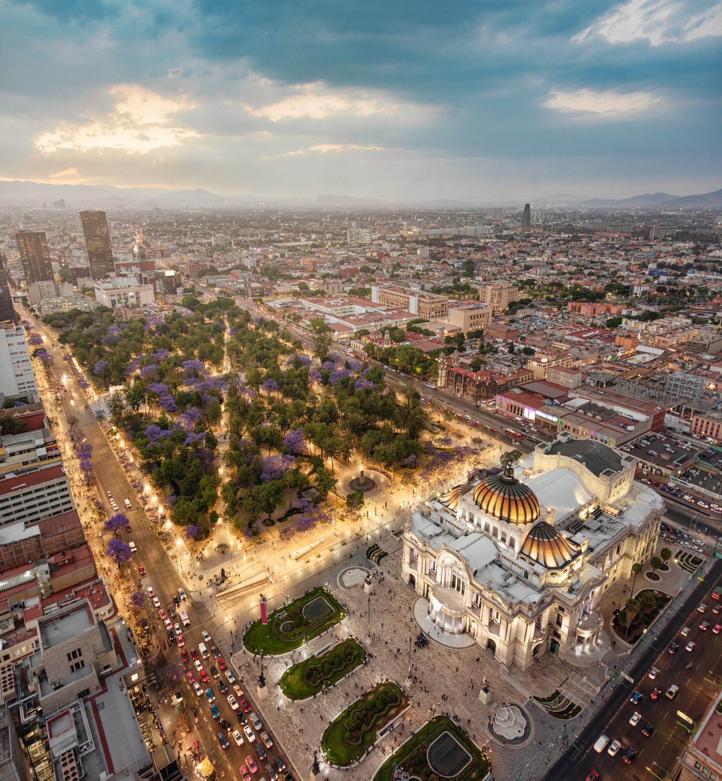Mexico city aerial view from Torre Latinoamericana. Palacio de Bellas Artes, Alameda Central and downtown in lights at sunset.